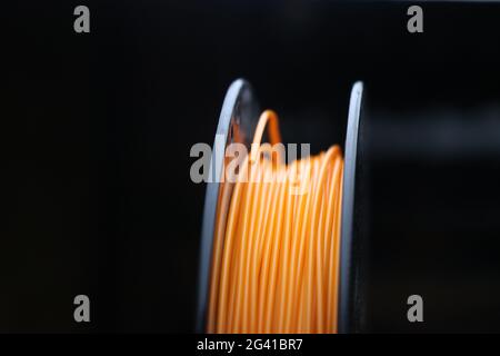Close-up of 3D Printing filament in a spool used for rapid prototype manufacturing methods. Stock Photo