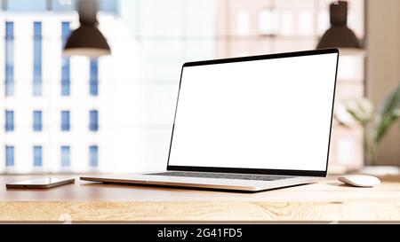 Laptop with frameless blank screen mockup template on the table in industrial office loft interior Stock Photo