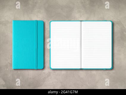 Aqua blue closed and open lined notebooks on concrete background Stock Photo