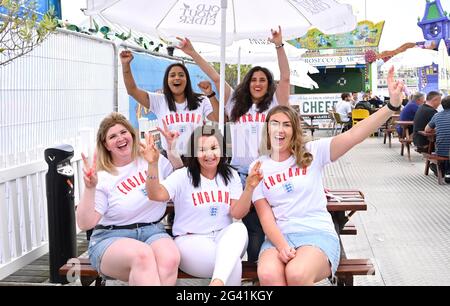 Brighton, UK.  18th June 2021 - England fans out in Brighton this evening ready for tonights match against Scotland in the UEFA European Championship  : Credit Simon Dack / Alamy Live News Stock Photo