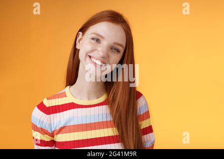 Pleasant charismatic young confident carefree redhead charming girl tilting head smiling broadly white teeth talking casually go Stock Photo
