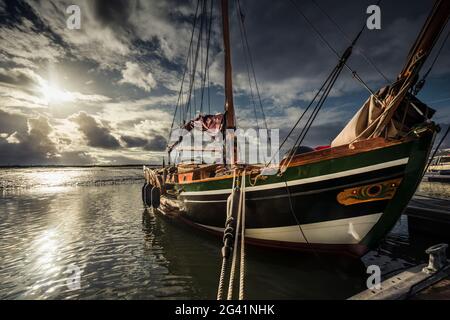 Morning mood with a traditional sailing boat in the Wadden Sea National Park, Spiekeroog, East Frisia, Lower Saxony, Germany, Europe Stock Photo