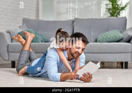 daughter congratulates her father and gives him postcard. Stock Photo