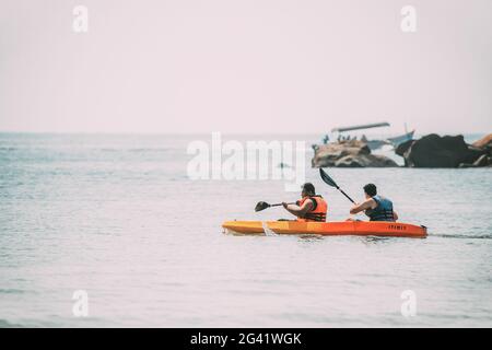 Anjadip, Goa, India. Two Men Swiming In Arabian Sea Kayaking In Summer Sunny Day Stock Photo
