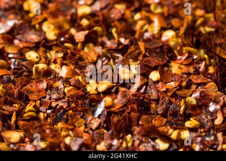 Organic Raw Red Pepper Flakes in a Bowl Stock Photo