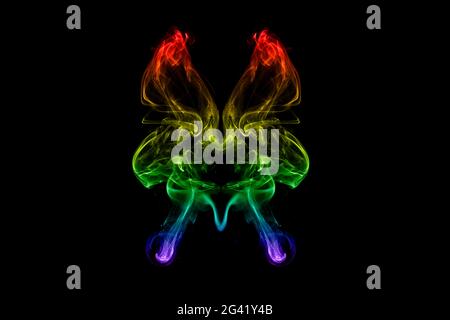 Colorful smoke with butterfly shape Stock Photo