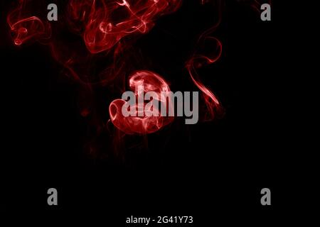 Red smoke on black background. Heart shaped smoke Stock Photo