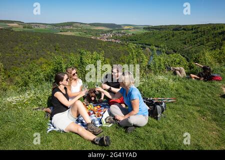 People enjoying a picnic on a slope above the Main, Wertheim, Spessart-Mainland, Franconia, Baden-Wuerttemberg, Germany, Europe Stock Photo