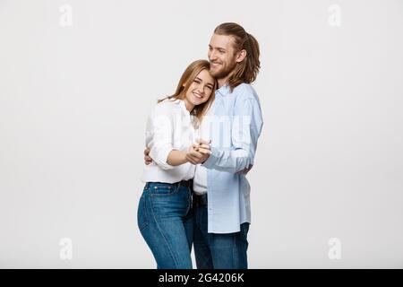 Young elegant couple in casual cloth dancing over Isolated on white studio background. Stock Photo