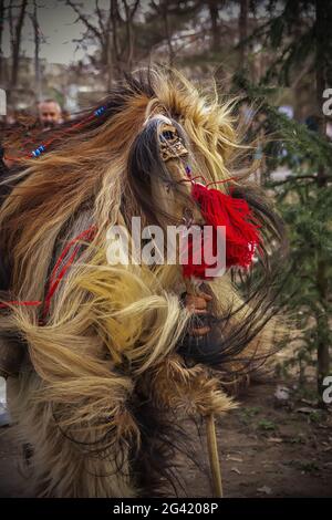 Mummers perform rituals to scare evil spirits people with the masks are called Kuker or kukeri in Pernik, Bulgaria Stock Photo