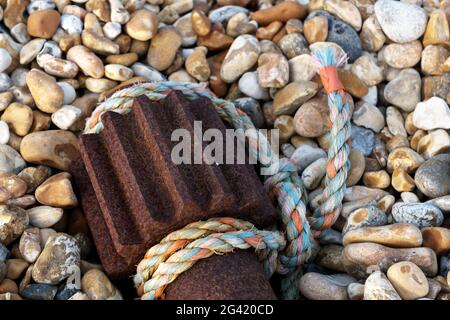 Nylon rope and old winch gear laying on the beach at Dungeness Stock Photo