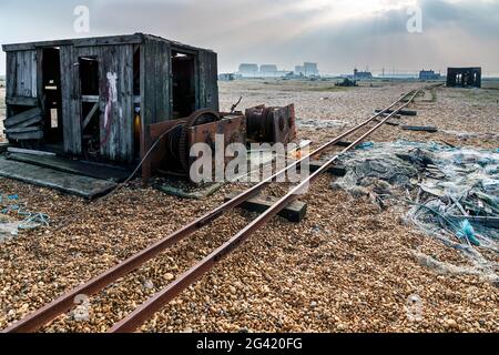 Old shack and rusty machinery on Dungeness beach Stock Photo