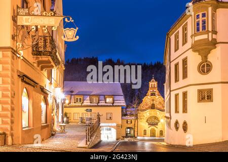 Heilig-Geist-Spitalkirche in the old town of Füssen in the evening, Allgäu, Bavaria, Germany Stock Photo