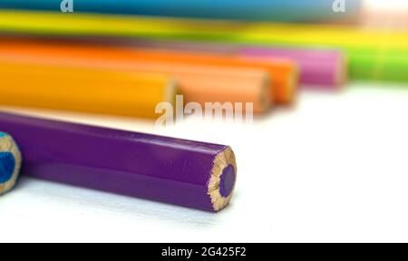 Multicolored drawing pencils on white office table background Stock Photo