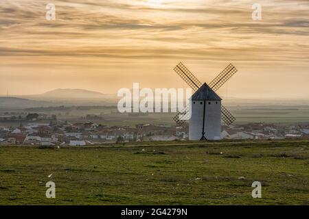 Whiteashed Spanish windmill above the plains of La Mancha in central Spain at sunset Stock Photo