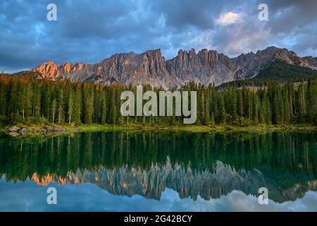 Latemar group is reflected in Karersee, Karersee, Rosengarten, Dolomites, UNESCO World Natural Heritage Dolomites, South Tyrol, Italy Stock Photo