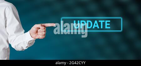 Male hand points to the word update. Internet technology software concept. Stock Photo