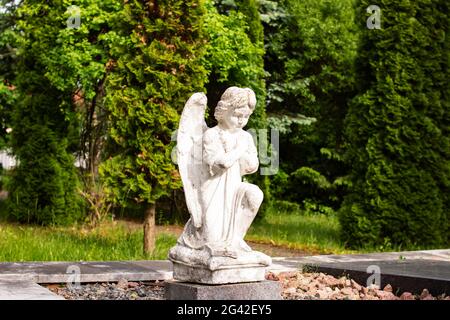 White angel statue in the park close up Stock Photo