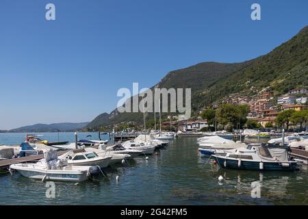 LAKE ISEO,  LOMBARDY/ITALY - AUGUST 15 : View of buildings and boats along the shore of Lake Iseo in Lombardy on August 15, 2020 Stock Photo