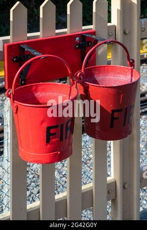 EAST GRINSTEAD, WEST SUSSEX/UK - AUGUST 30 : Two fire buckets at East Grinstead Bluebell railway station West Sussex on August 3 Stock Photo