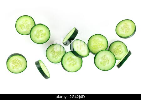 Cucumber slices, falling in the air on a white background Stock Photo