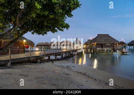 Pier to overwater bungalows at the Hilton Moorea Lagoon Resort & Spa, Moorea, Windward Islands, French Polynesia, South Pacific Stock Photo