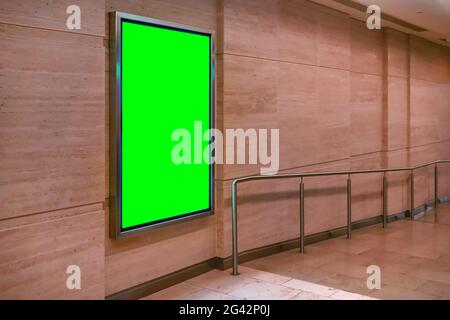 Wall with light display ad board - green color advertisement mock up Stock Photo