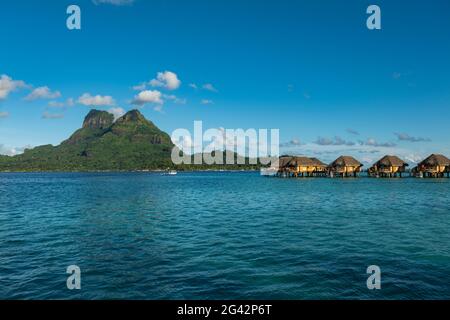 Overwater bungalows of the Bora Bora Pearl Beach Resort and Mount Otemanu, Bora Bora, Leeward Islands, French Polynesia, South Pacific Stock Photo