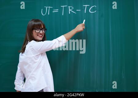 The professor explains the task on the board Stock Photo