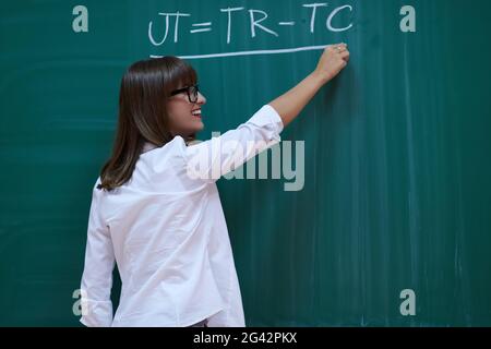 The professor explains the task on the board Stock Photo