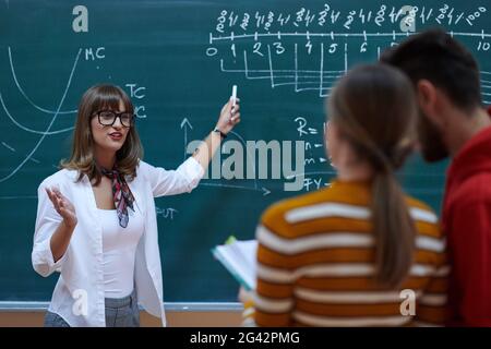 The professor explains the task on the board Stock Photo
