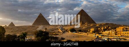 Giza pyramids on horizon at sunset, Al Haram, Giza Governate, Egypt Stock Photo