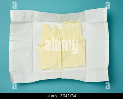 Sterile medical white gloves in white paper on a blue background Stock Photo