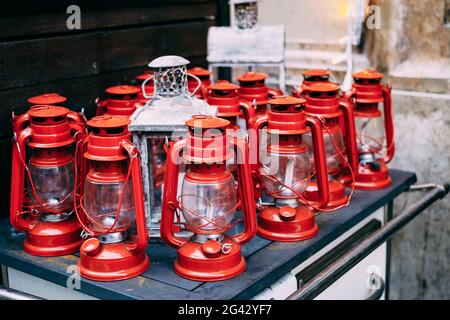 Red kerosene lanterns. 13 red lights and 1 white wooden Stock Photo