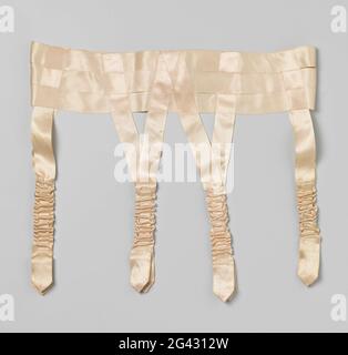 Suspender belt of salmon-colored satin strap. Suspender belt of salmon-colored satin strap. Model: The waistband is made up of three satin ribbons above each other from 2.8 cm wide where four times the double dependent ribbons are braided and sewn. Closure in the middle back through two mother-of-pearl buttons and two loops of folded satin. At the right end, among the two buttons, two 7.5 cm long pieces of elastic are applied that are camouflaged by a controlled satin upholstery. The same elastic (camouflaged in the same way), but in some form has also been processed in the dependent ribbons. Stock Photo