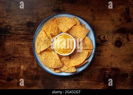 Nacho chips with a cheese dip, overhead shot Stock Photo
