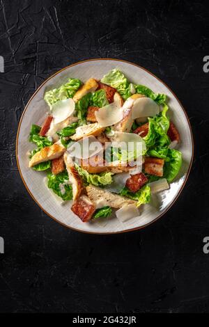 Chicken Caesar salad with lettuce and cheese, shot from the top Stock Photo