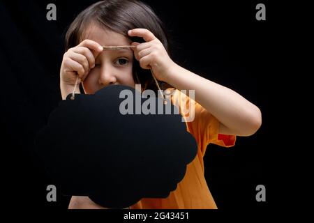 Little boy holding an empty advertising sign board in hand Stock Photo