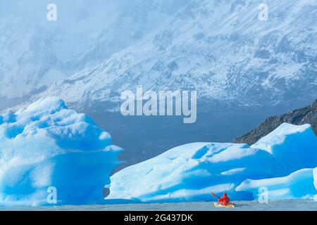 Kayaker paddles among icebergs, Torres del Paine National Park, Patagonia, Chile, South America Stock Photo