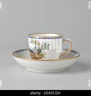 Cup and saucer of Pâte tendre porcelain. Cup and saucer of multicolored Pâte-Tendre porcelain de saucer is painted with a landscape in which a colorful bird. The edges are decorated with blue and gold. The head is marked, O.A. With a rectangle in which a cross is drawn. See also the corresponding heads and bk-kog-1752-1 and -2 dishes. Stock Photo