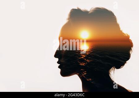 Psychology concept. Sunrise and woman silhouette Stock Photo