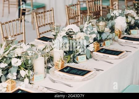 Wedding table setting decor with white flowers Stock Photo