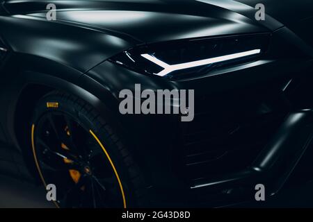 Moscow Russia - February 10, 2019: Lamborghini Urus black sport car headlights. Sports cars street race Stock Photo