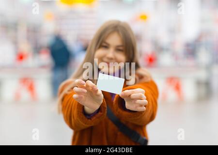 Young woman holds credit card in hands. Stock Photo