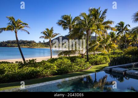 Private swimming pool of a Residence Villa accommodation with coconut trees and beach in Six Senses Fiji Resort, Malolo Island, Mamanuca Group, Fiji I Stock Photo