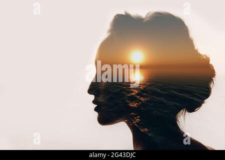 Psychology concept. Sunrise and woman silhouette Stock Photo