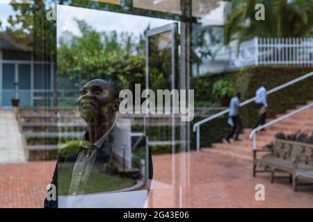 Thoughtful Rwandan man and reflection in window at the Kigali Genocide Memorial Center, Kigali, Kigali Province, Rwanda, Africa Stock Photo