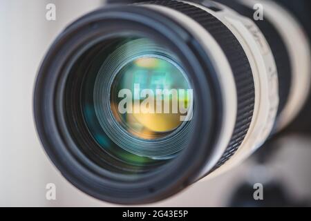 Photography concept: Close up of telephoto lens, camera on a tripod Stock Photo
