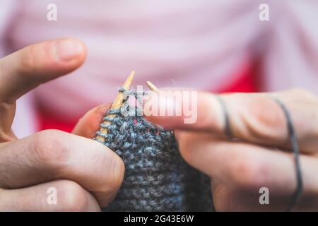 Knitting at home: Close up of wool, thread and female fingers Stock Photo