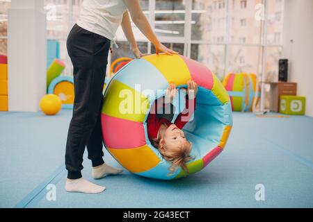 Kids playing in gym at kindergarten or elementary school. Children sport and fitness concept. Stock Photo